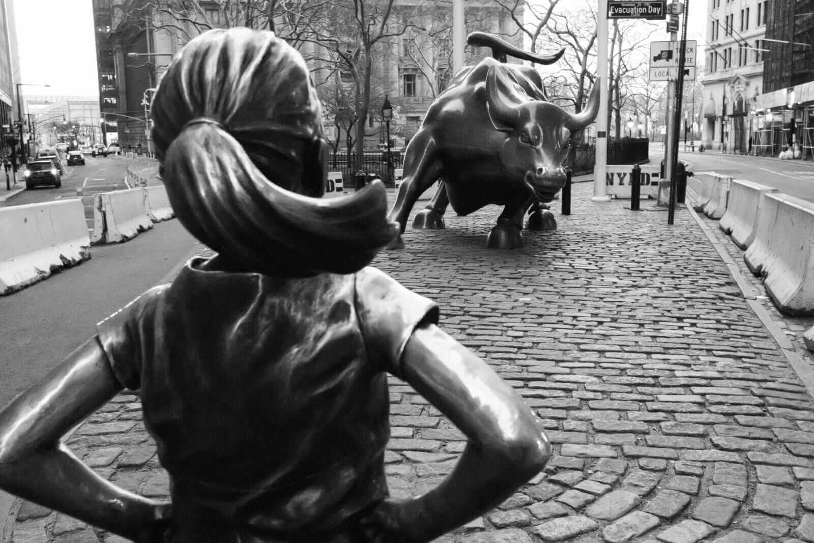 Fearless girl in front of bull on Wall Street by Daniel Lloyd Blunk-Fernandez via Unsplash
